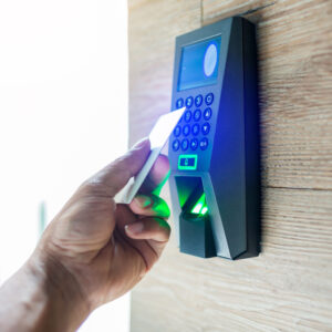 Door access control. Staff holding a key card to lock and unlock door at home or condominium