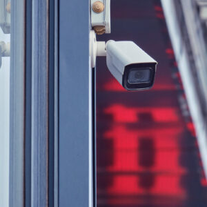 Video surveillance camera on the store building, monitoring the security of the entrance to the shopping center