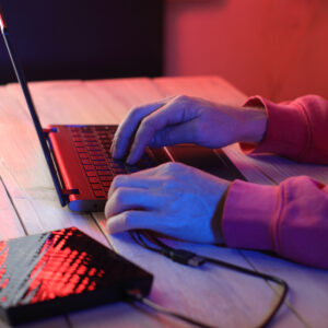 laptop with attached optical drive on the table in front of a person