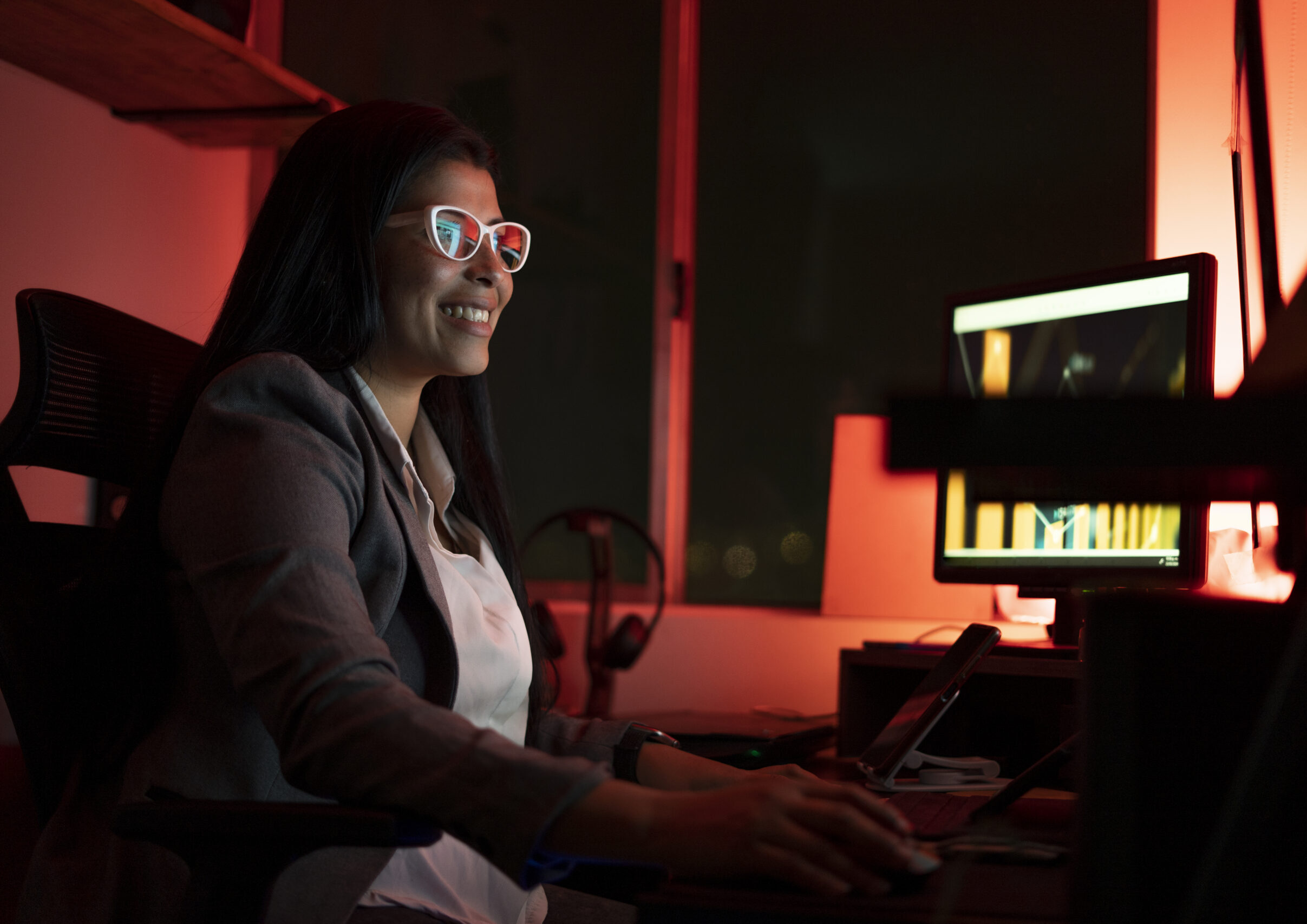 young businesswoman using a computer during a late night at work