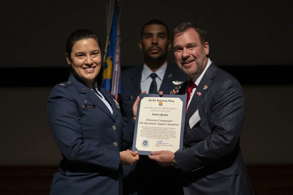 Source 1 Solutions leaders receiving a certificate from a U.S. Air Force service member at an awards ceremony