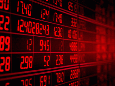 Financial market ticker board displaying stock prices in red