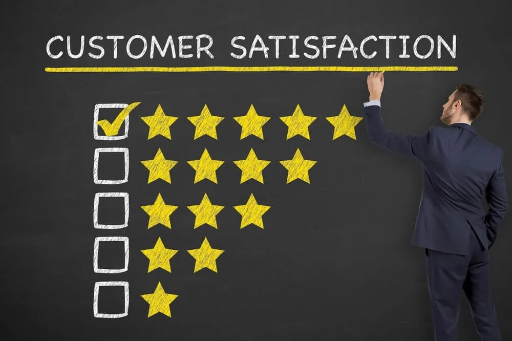 Businessman ticking the top five-star box on a customer satisfaction rating chart