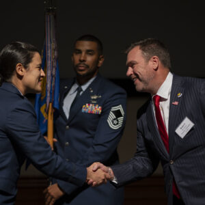 Robert Hessel shaking hands with a U.S. Air Force service member at the MacDill honorary commander ceremony