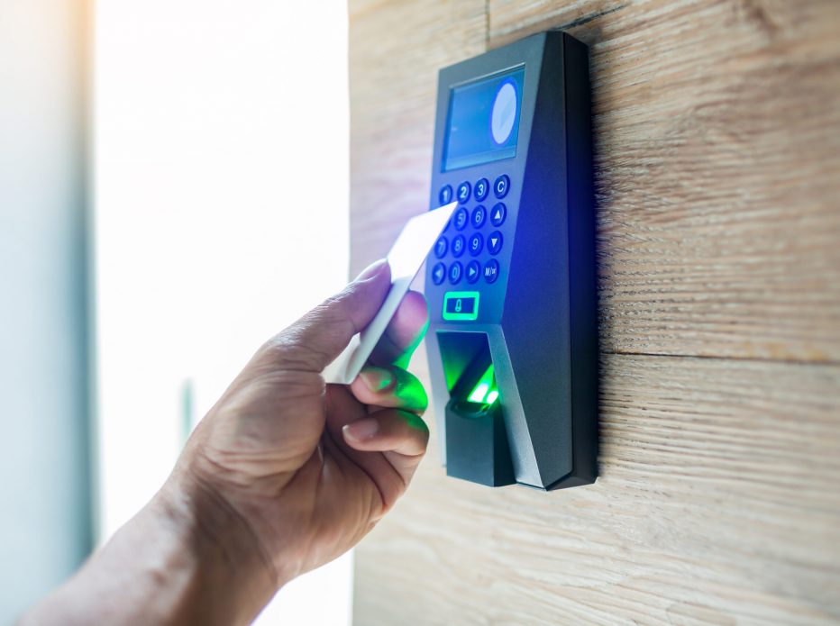 Door access control. Staff holding a key card to lock and unlock door at home or condominium. using electronic card key for access. electronic key and finger scan access control system to unlock doors